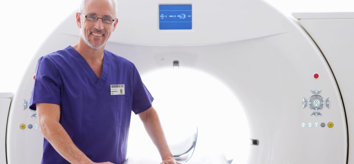 a-smiling-doctor-standing-beside-the-ct-scanning-m-2026-01-11-09-42-07-utc a-smiling-doctor-standing-beside-the-ct-scanning-m-2026-01-11-09-42-07-utc